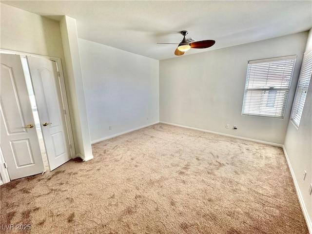 unfurnished bedroom featuring baseboards, carpet flooring, and ceiling fan