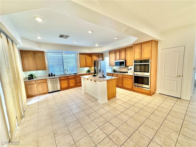 kitchen with light countertops, appliances with stainless steel finishes, light tile patterned floors, and visible vents