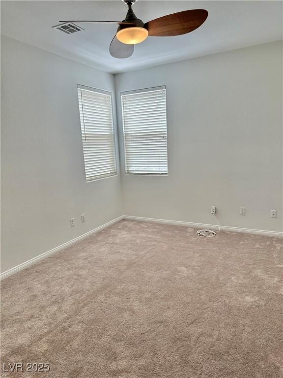 carpeted spare room with baseboards and a healthy amount of sunlight