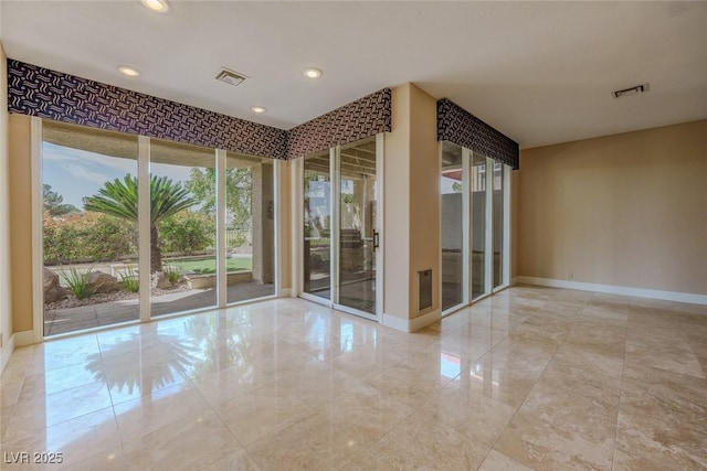empty room featuring visible vents, recessed lighting, and baseboards