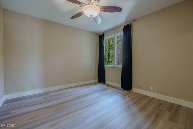 spare room featuring ceiling fan, wood finished floors, and baseboards
