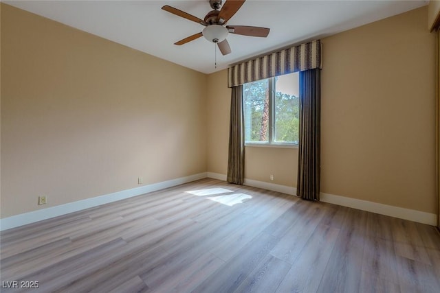 unfurnished room with ceiling fan, baseboards, and light wood-style floors