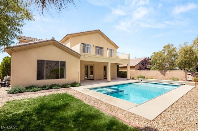 17 Morninglow Pass, Henderson, NV 89052 - back of house with stucco siding, fence, a pool with connected hot tub, a patio area, and a balcony