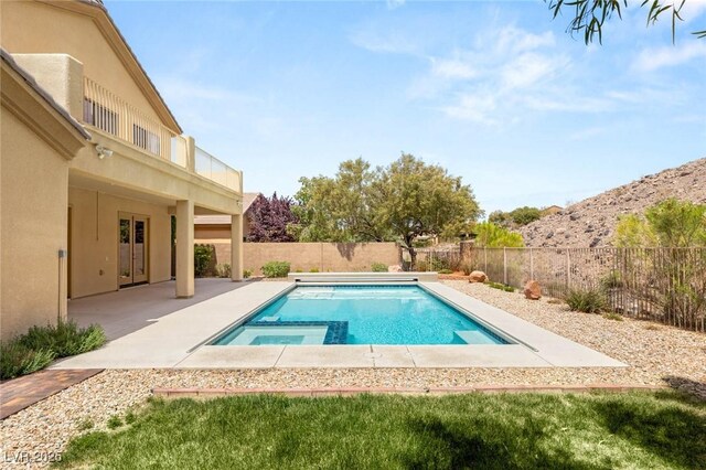17 Morninglow Pass, Henderson, NV 89052 - view of swimming pool featuring a patio, a fenced backyard, and a pool with connected hot tub