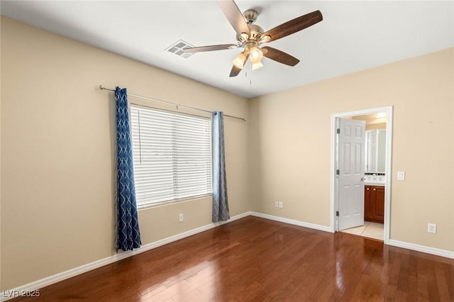 17 Morninglow Pass, Henderson, NV 89052 - unfurnished bedroom with connected bathroom, a ceiling fan, visible vents, baseboards, and wood finished floors