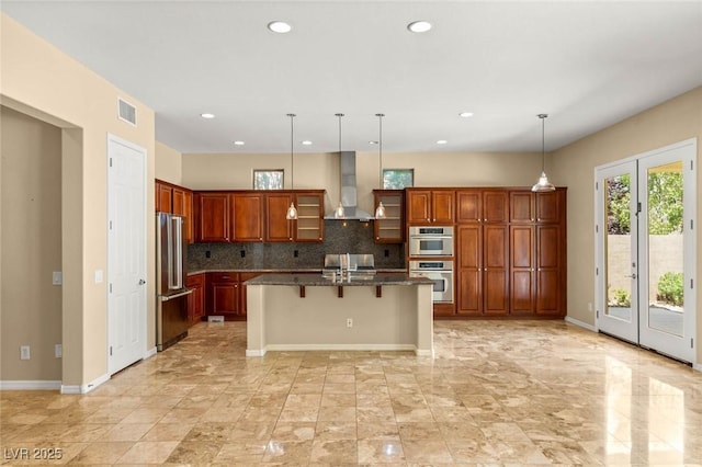 17 Morninglow Pass, Henderson, NV 89052 - kitchen with wall chimney range hood, decorative backsplash, appliances with stainless steel finishes, a breakfast bar, and recessed lighting