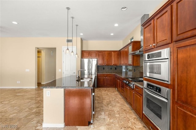 17 Morninglow Pass, Henderson, NV 89052 - kitchen featuring a kitchen island with sink, a sink, stainless steel appliances, dark stone countertops, and tasteful backsplash