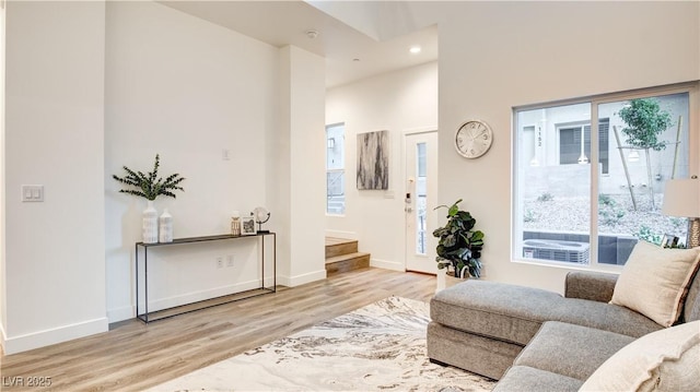 1187 Blossom Point St Unit 36, Las Vegas, NV 89135 - living room featuring baseboards, recessed lighting, wood finished floors, a high ceiling, and stairs