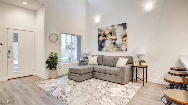 1187 Blossom Point St Unit 36, Las Vegas, NV 89135 - living room with baseboards, recessed lighting, wood finished floors, and a towering ceiling