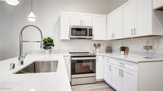1187 Blossom Point St Unit 36, Las Vegas, NV 89135 - kitchen with white cabinets, appliances with stainless steel finishes, and a sink
