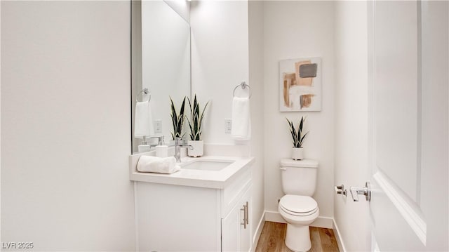 1187 Blossom Point St Unit 36, Las Vegas, NV 89135 - bathroom featuring baseboards, wood finished floors, toilet, and vanity