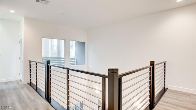 1187 Blossom Point St Unit 36, Las Vegas, NV 89135 - hallway with an upstairs landing, visible vents, baseboards, and light wood-style floors