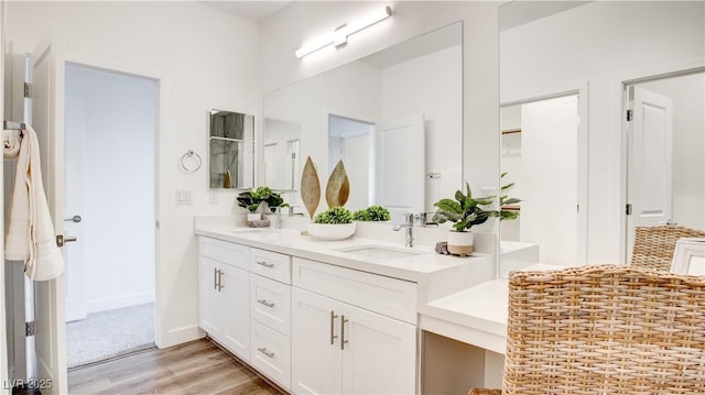 1187 Blossom Point St Unit 36, Las Vegas, NV 89135 - bathroom with double vanity, wood finished floors, baseboards, and a sink