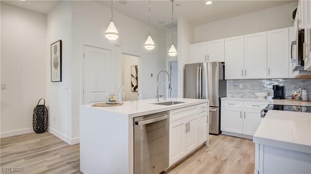 1181 Blossom Point St, Las Vegas, NV 89135 - kitchen with a sink, light wood-style flooring, stainless steel appliances, and light countertops