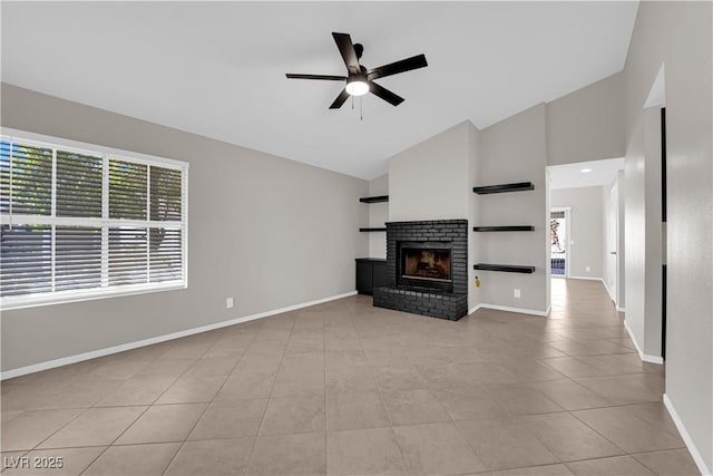 unfurnished living room featuring tile patterned floors, baseboards, a fireplace, a ceiling fan, and high vaulted ceiling
