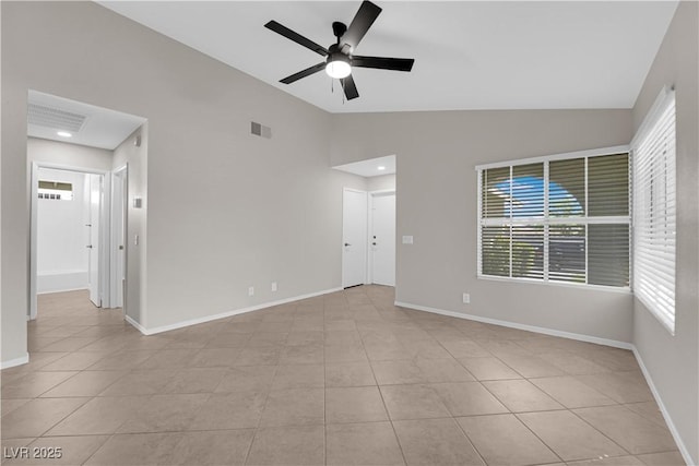 unfurnished room with lofted ceiling, light tile patterned floors, visible vents, a wealth of natural light, and a ceiling fan