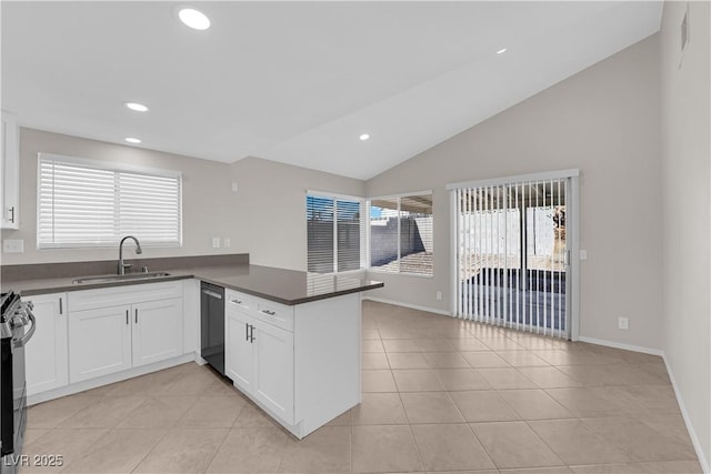 kitchen with a sink, light tile patterned floors, a peninsula, dark countertops, and dishwasher