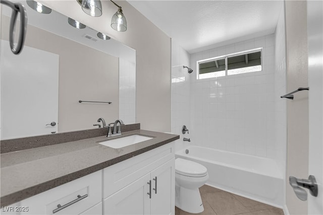 bathroom featuring shower / tub combination, visible vents, toilet, vanity, and tile patterned flooring
