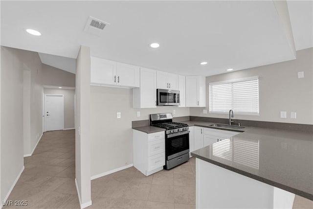 kitchen featuring visible vents, stainless steel appliances, light tile patterned floors, and a sink