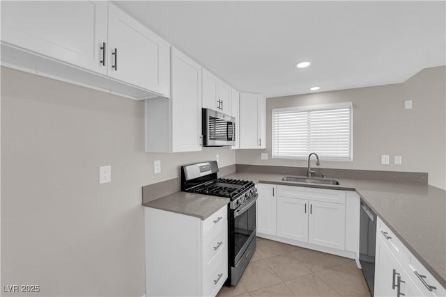 kitchen featuring light tile patterned floors, white cabinets, a sink, stainless steel appliances, and recessed lighting
