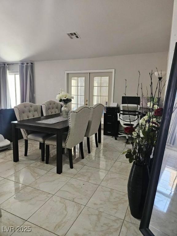 dining room featuring visible vents, french doors, and marble finish floor
