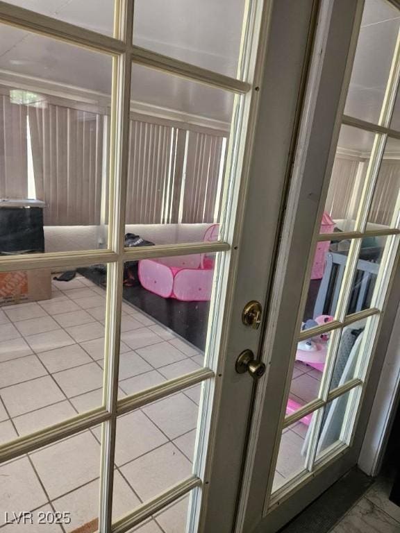 doorway to outside with tile patterned flooring