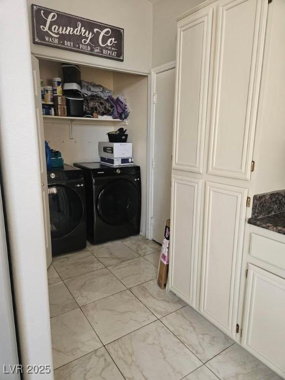 clothes washing area featuring washing machine and clothes dryer and marble finish floor