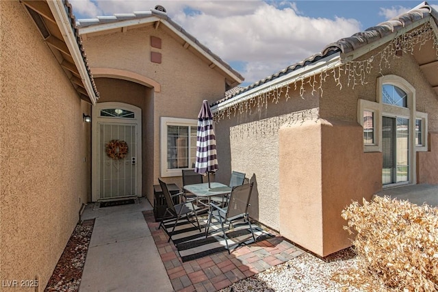 2631 Bed Knoll Ct, North Las Vegas, NV 89031 - doorway to property with a patio area, stucco siding, and outdoor dining space