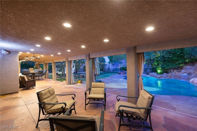 view of patio / terrace featuring outdoor dining area and an outdoor pool