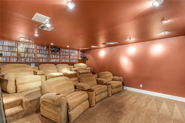 cinema with carpet, visible vents, a textured ceiling, and baseboards