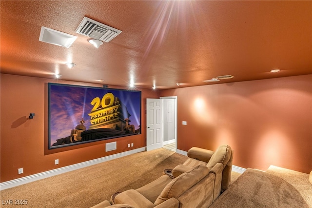 home theater room with baseboards, visible vents, carpet floors, and a textured ceiling