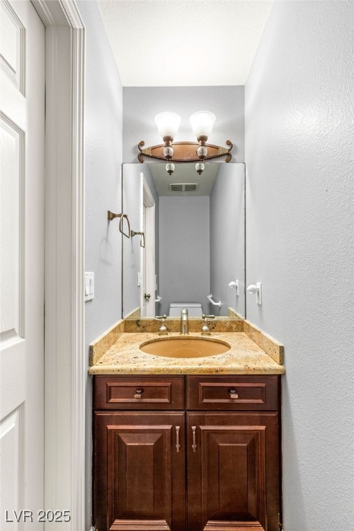 half bath with visible vents and vanity