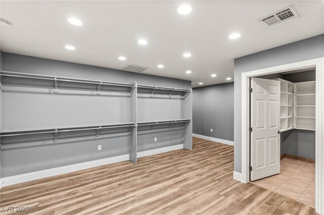 walk in closet featuring visible vents and light wood-style floors