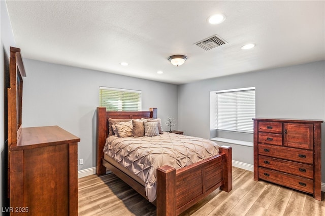 bedroom with visible vents, baseboards, recessed lighting, and light wood-style floors
