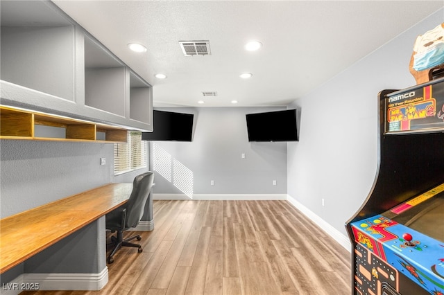 office featuring visible vents, recessed lighting, light wood finished floors, and baseboards