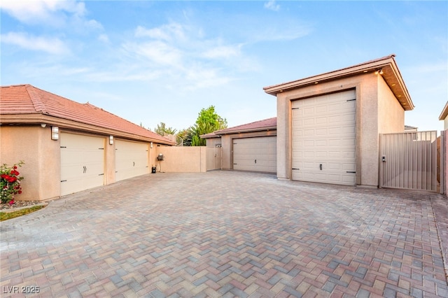 garage with fence and a gate