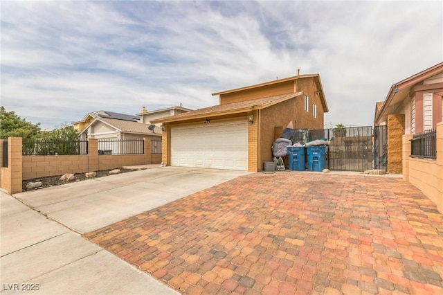 view of front of house with a garage, brick siding, fence, and concrete driveway