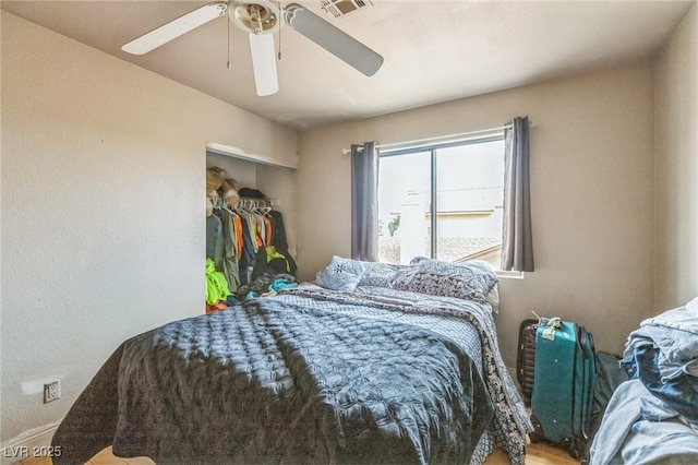 bedroom with a ceiling fan, visible vents, a closet, and baseboards