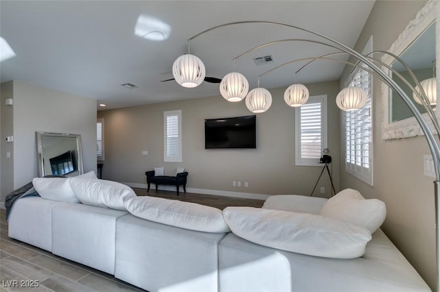 living area featuring visible vents and baseboards