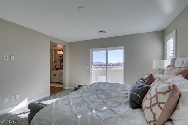 bedroom with carpet floors, access to exterior, ensuite bathroom, baseboards, and visible vents