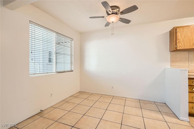 empty room featuring light tile patterned floors and a ceiling fan