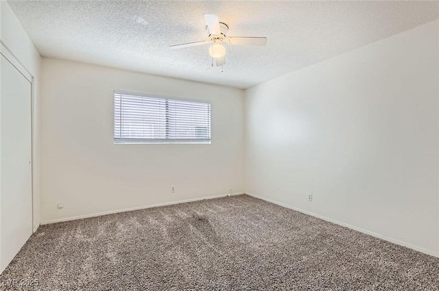unfurnished room with baseboards, a ceiling fan, a textured ceiling, and carpet