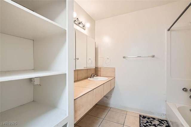 bathroom featuring tile patterned floors, vanity, and bathing tub / shower combination