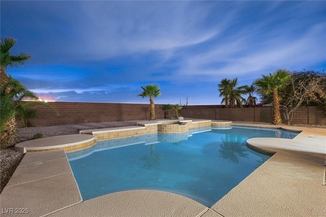 pool at dusk with a fenced in pool and a fenced backyard