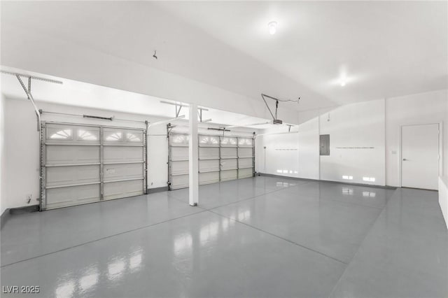 garage with baseboards, a garage door opener, and electric panel