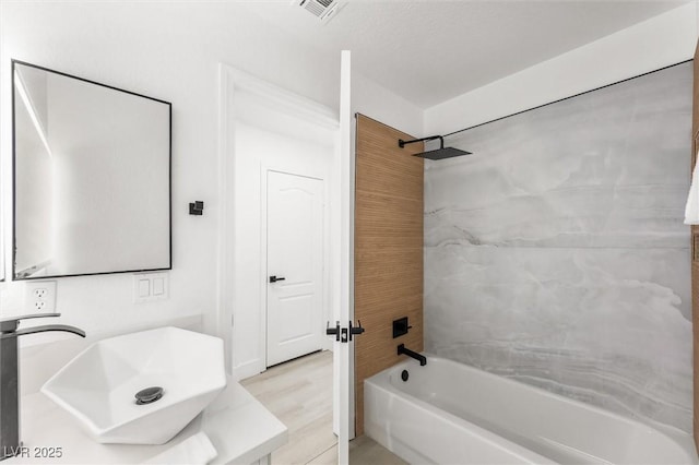 bathroom with visible vents, tub / shower combination, and vanity
