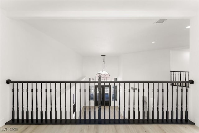 additional living space with visible vents and wood finished floors