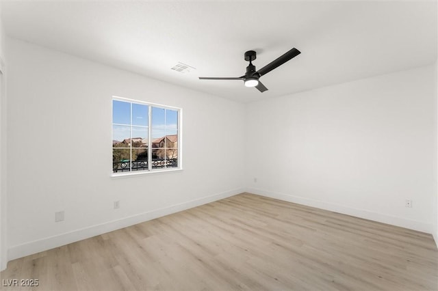 unfurnished room with baseboards, ceiling fan, visible vents, and light wood-style flooring