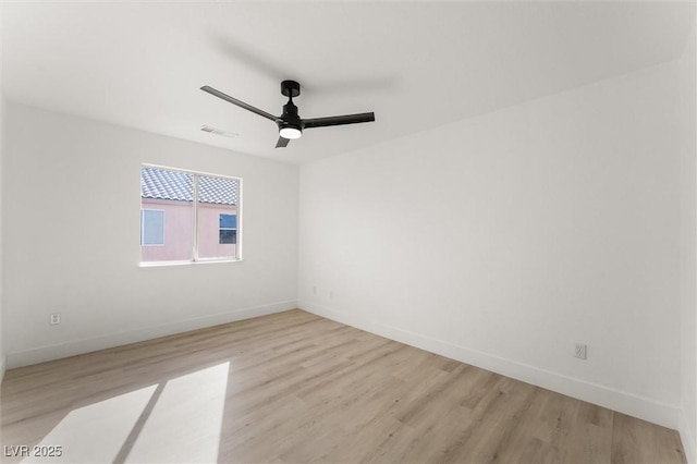 unfurnished room with baseboards, light wood finished floors, ceiling fan, and visible vents