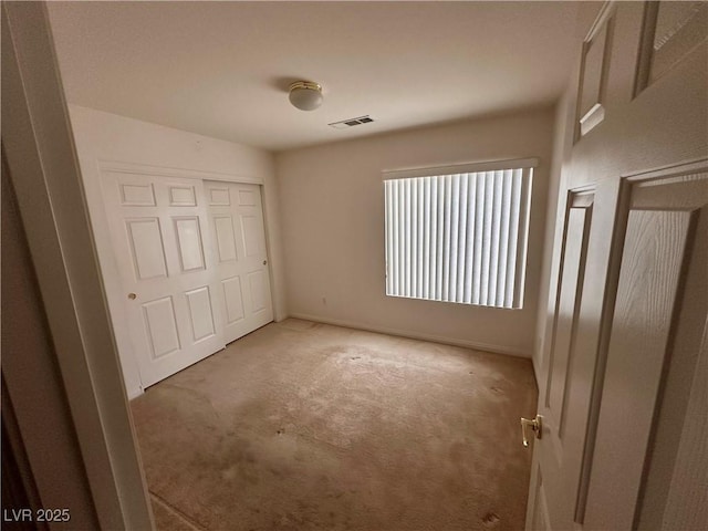 unfurnished bedroom with carpet flooring and a closet
